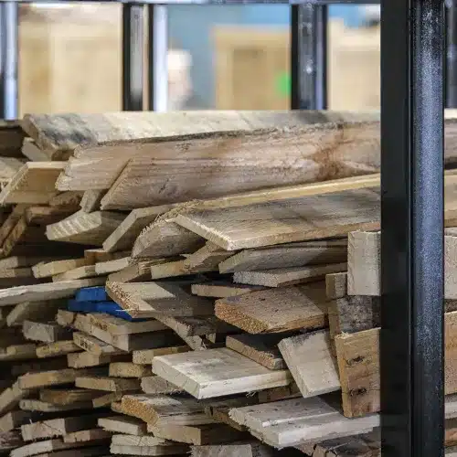 Used pallet boards collected in a bin